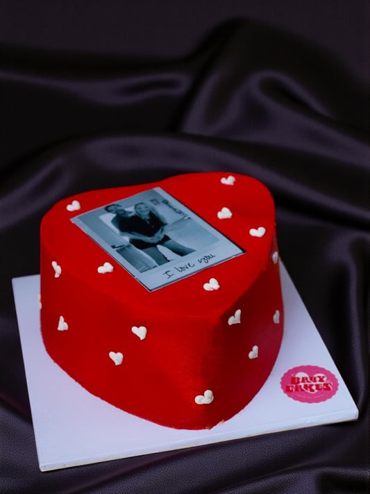 Valentines Polaroid Heart Cake - Our Polaroid Heart Cake is a 4-inch Valentine’s mini, covered in red buttercream, piped hearts and finished with your chosen photo. Serves 3-4.